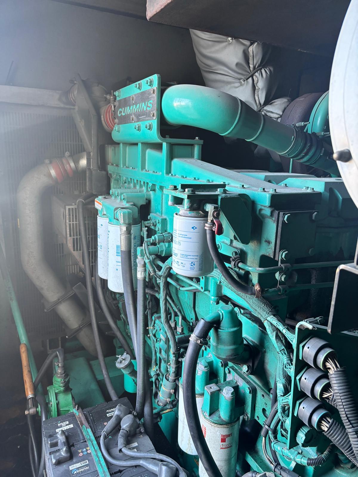 Cummins engine and pipework viewed through the access door - 2014 CPG C900 D5 Cummins containerised generator
